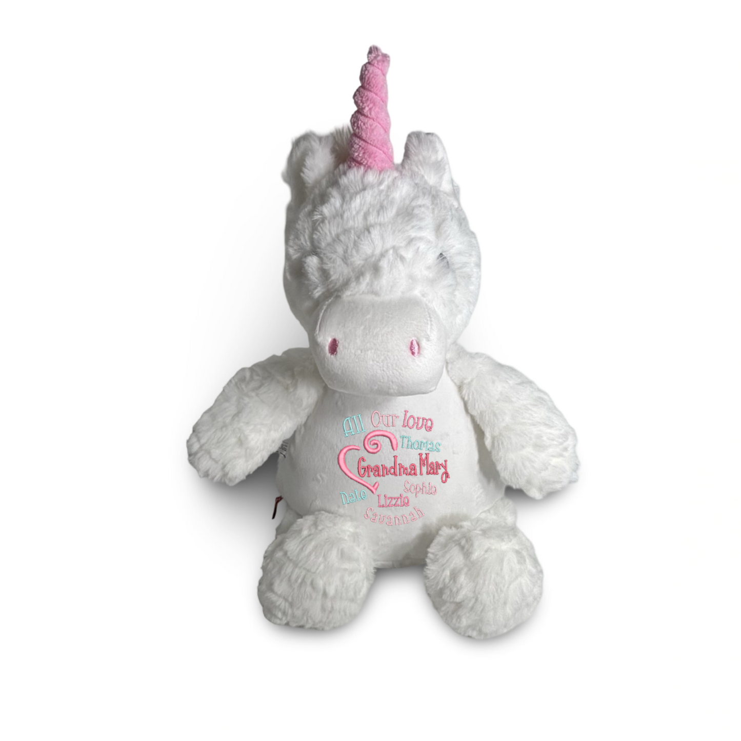 Plush unicorn toy with pink horn and embroidered text on a white background