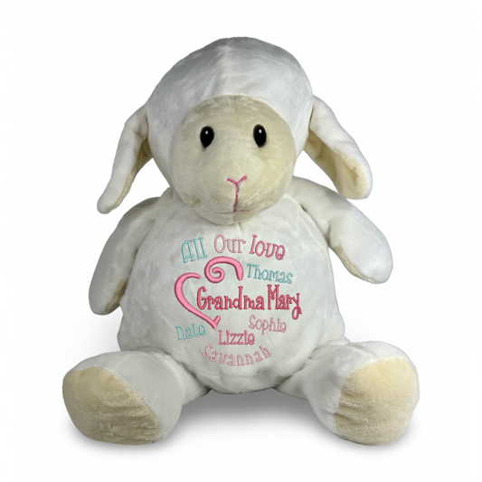 Plush lamb toy with embroidered message on a white background