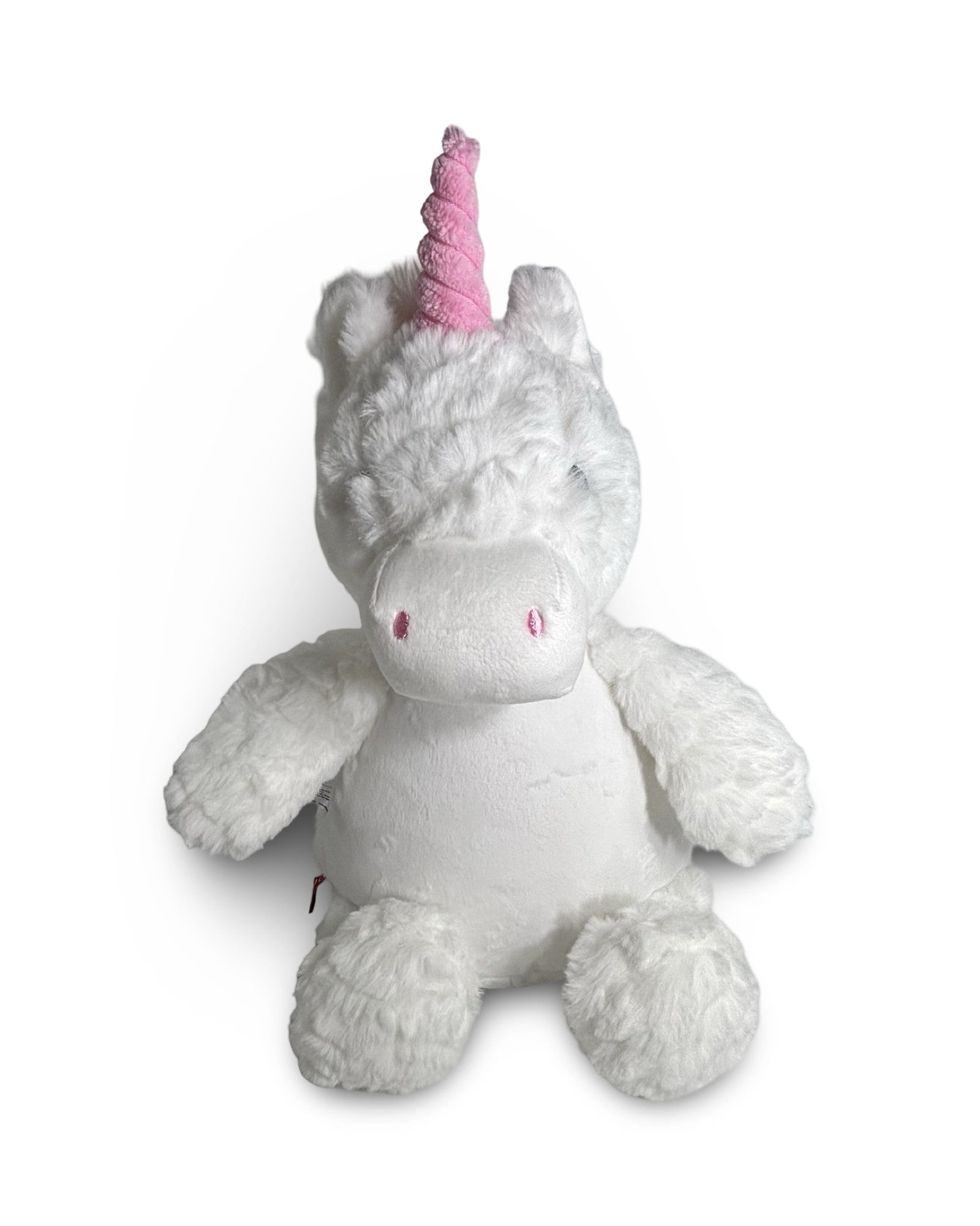 Plush unicorn toy with a pink horn on a white background
